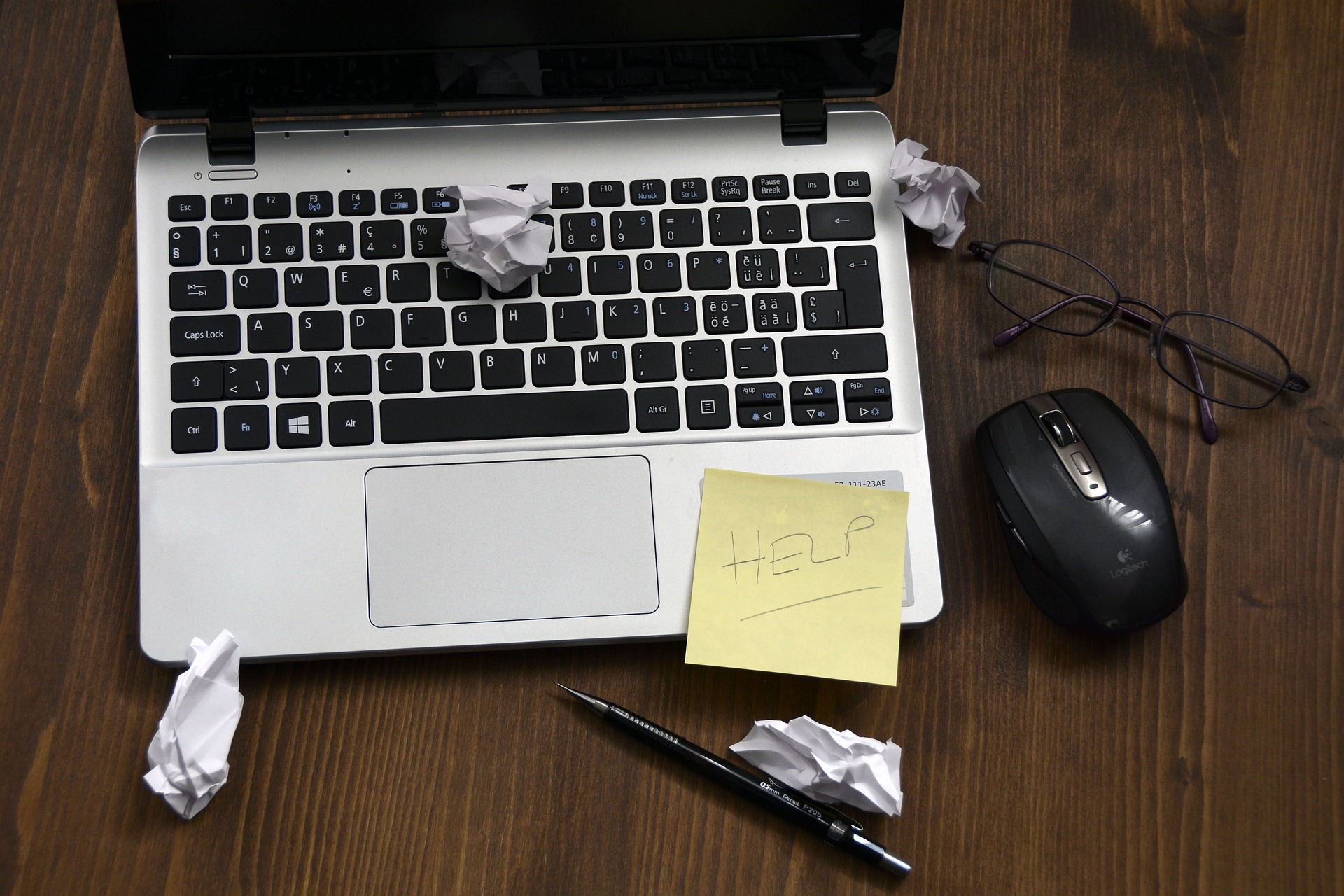 Hands typing on a laptop